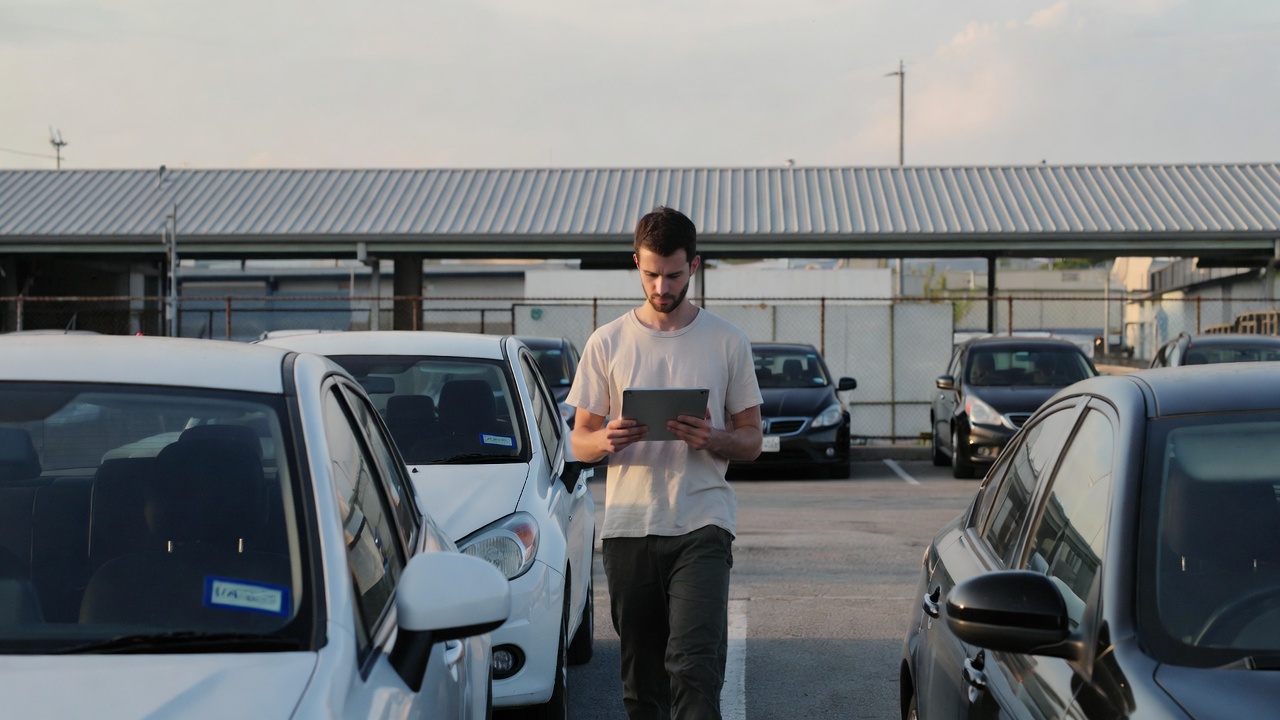 HOA manager verifying a parking permit in a condo parking lot